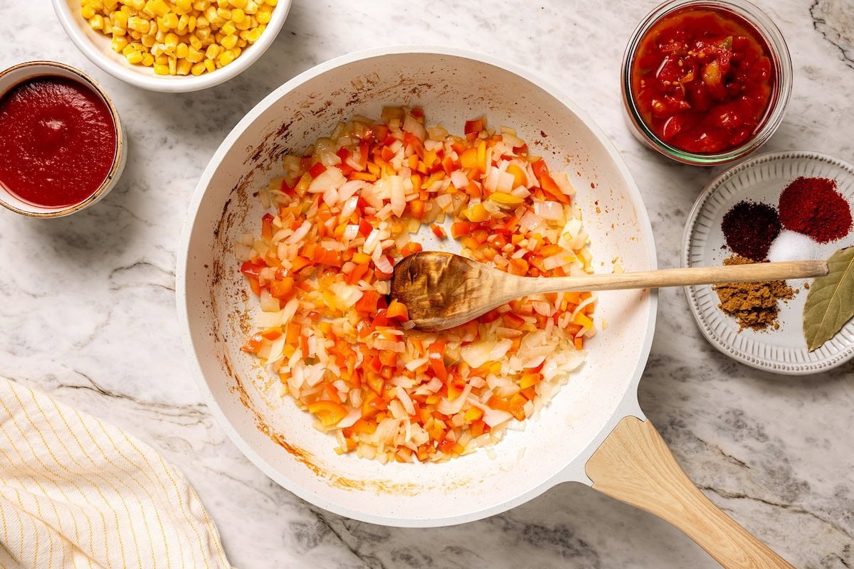 Sautéed diced vegetables in a skillet.